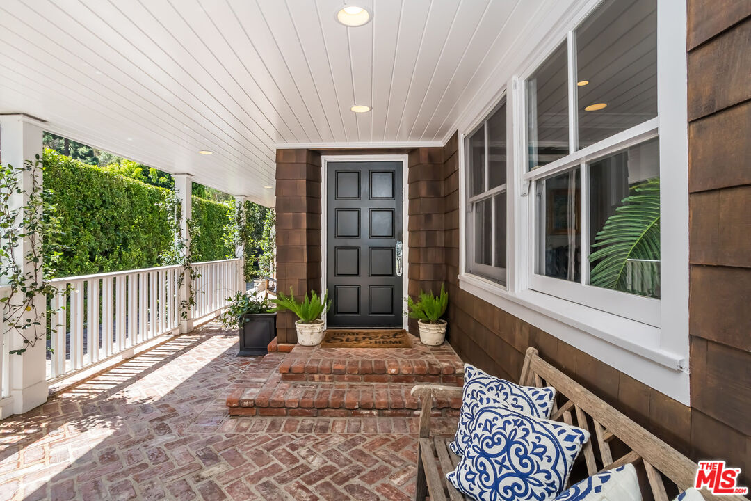 919 Chantilly Road Los Angeles, CA 90077 - Photo 4 of 23 a porch with a table and chairs