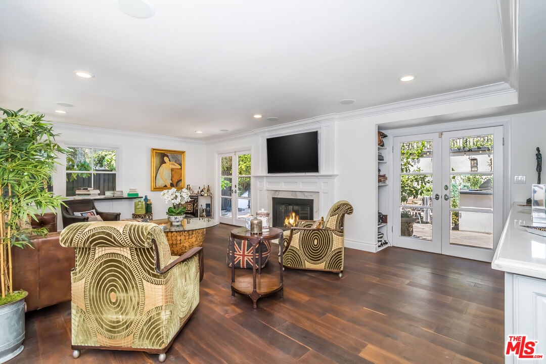 919 Chantilly Road Los Angeles, CA 90077 - Photo 6 of 23 a living room with furniture a fireplace and a flat screen tv