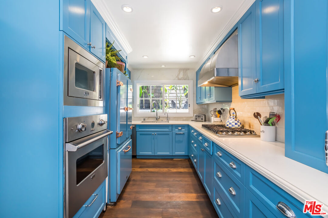 919 Chantilly Road Los Angeles, CA 90077 - Photo 10 of 23 a kitchen with stainless steel appliances granite countertop a stove and a sink