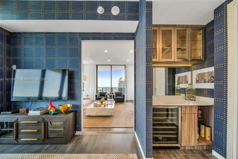 a living room with furniture and a dining table with rug