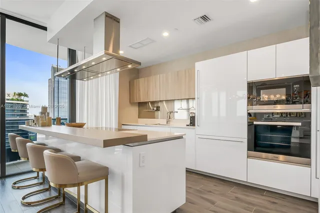 a kitchen with granite countertop a stove and a refrigerator