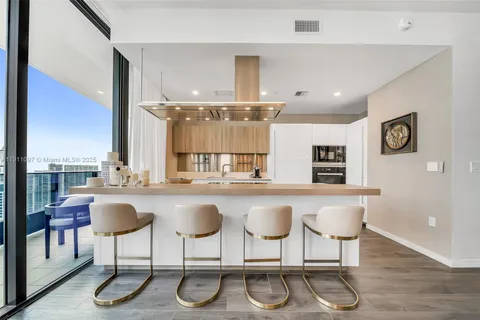 a kitchen with a table chairs stove and cabinets