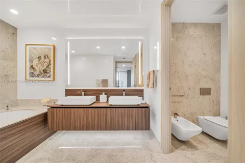 a bathroom with a tub sink and mirror