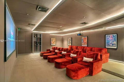 a media room with lots of chairs and a projector