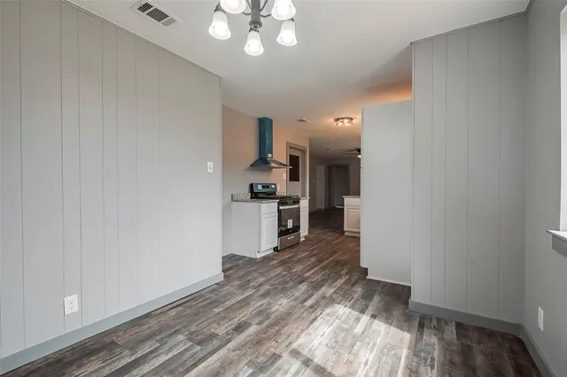 a open kitchen with cabinets and wooden floor