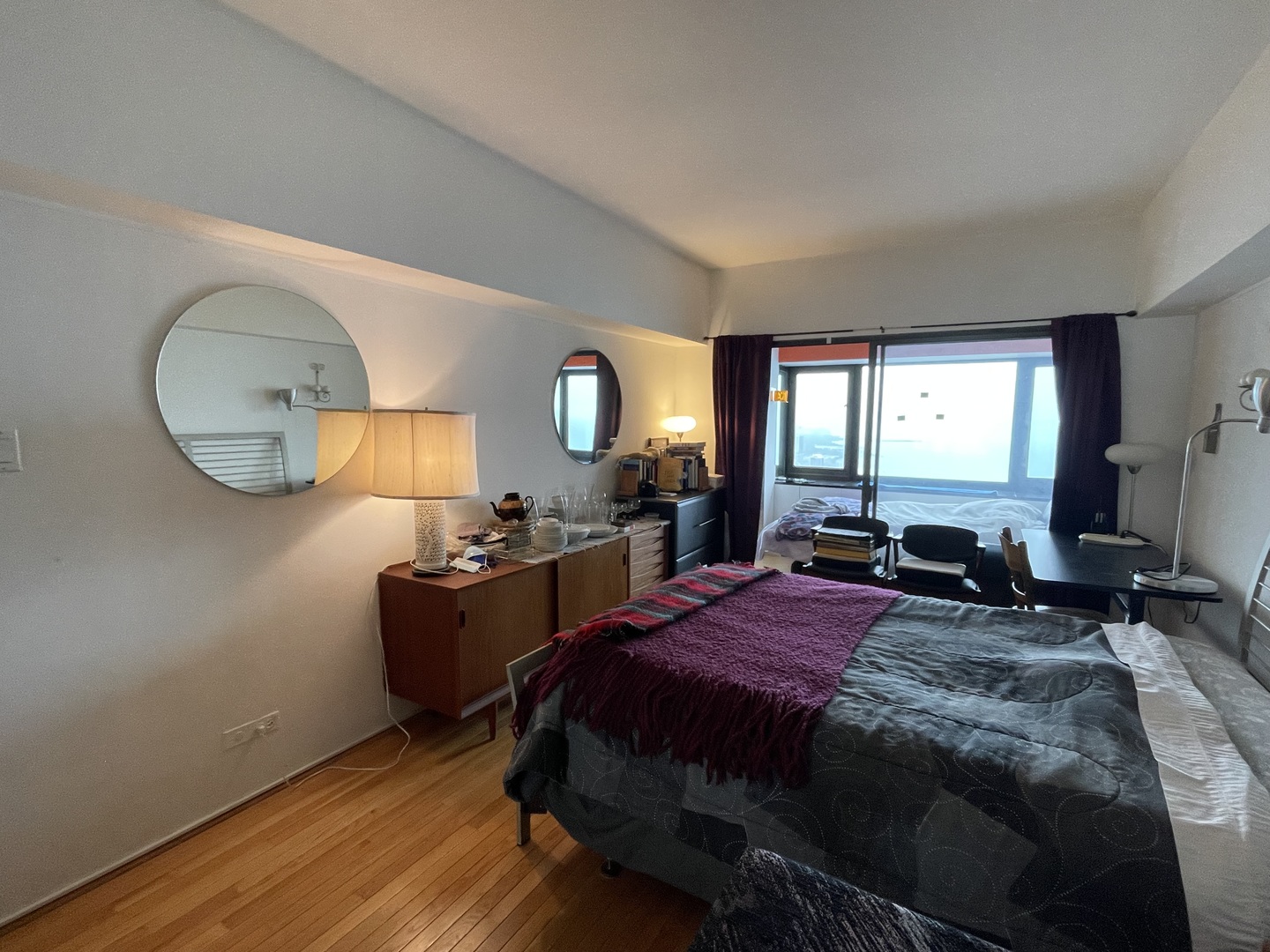 175 East Delaware Place, Unit 5604 Chicago, IL 60611 - Photo 12 of 21 a bedroom with a bed mirror on dresser and a large window