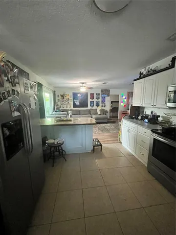 a kitchen with stainless steel appliances a stove a sink a refrigerator and cabinets