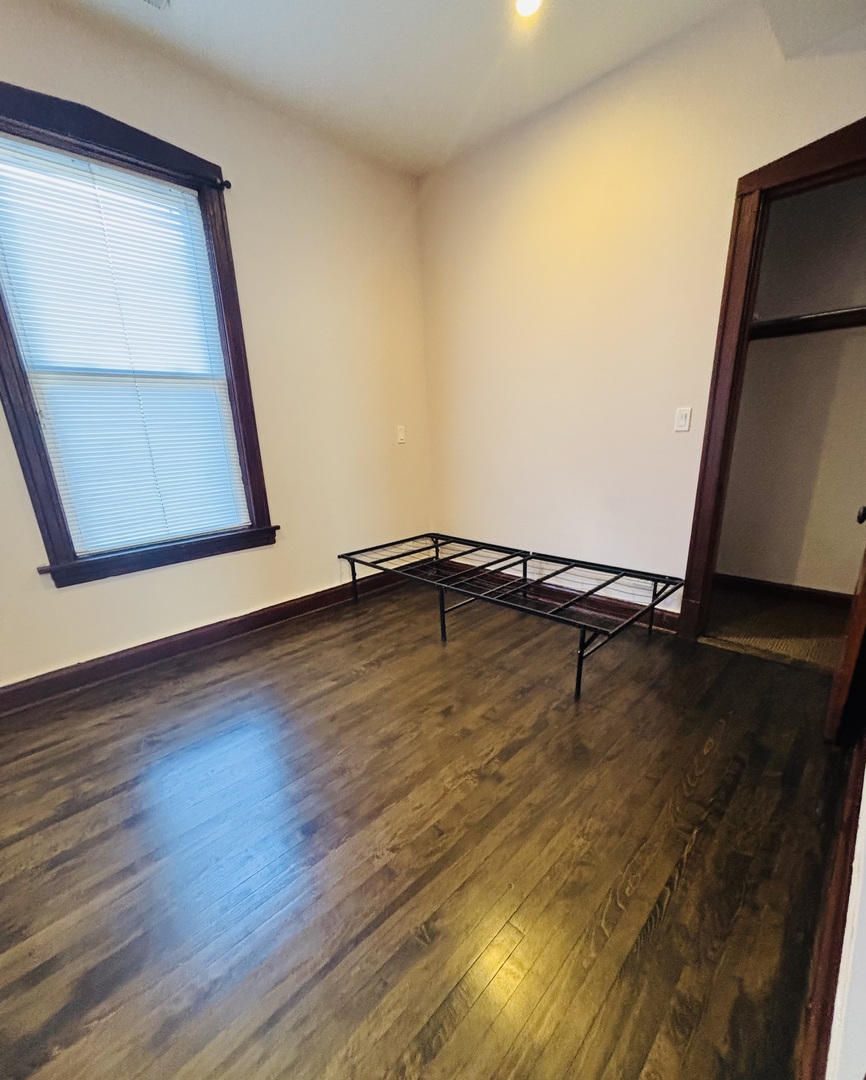 3133 North Richmond Street, Unit 2 Chicago, IL 60618 - Photo 12 of 16 a view of a room with wooden floor and bench
