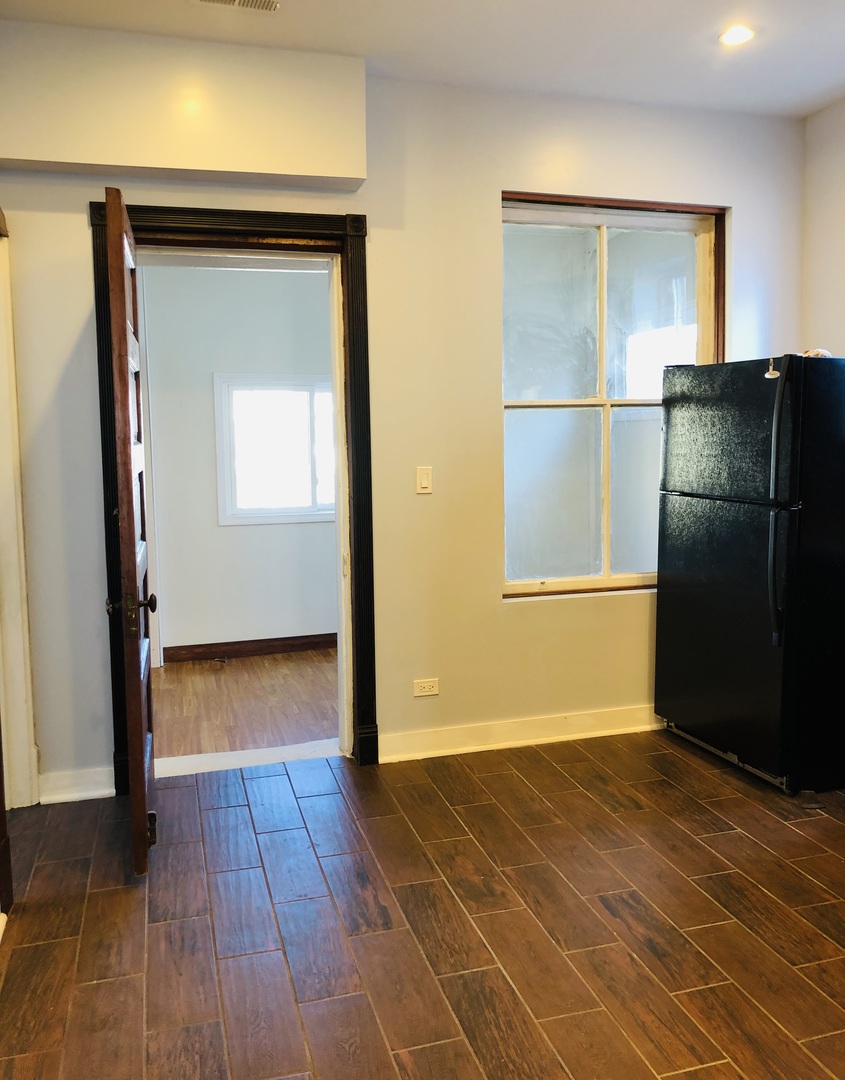 3133 North Richmond Street, Unit 2 Chicago, IL 60618 - Photo 14 of 16 a view of a livingroom with wooden floor and a refrigerator