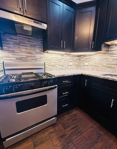 a kitchen with granite countertop stainless steel appliances and wooden cabinets