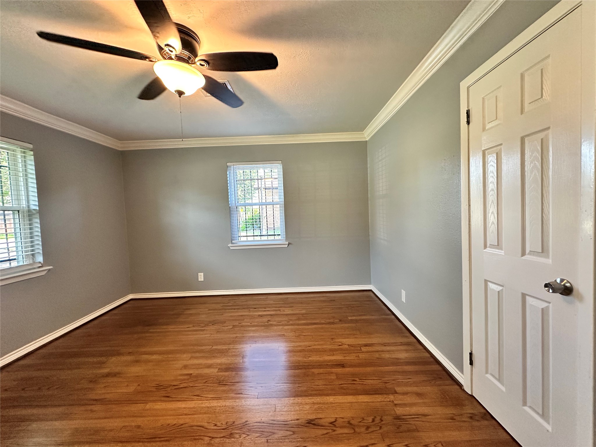 2206 South Houston Road Pasadena, TX 77502 - Photo 11 of 11 an empty room with wooden floor fan and windows