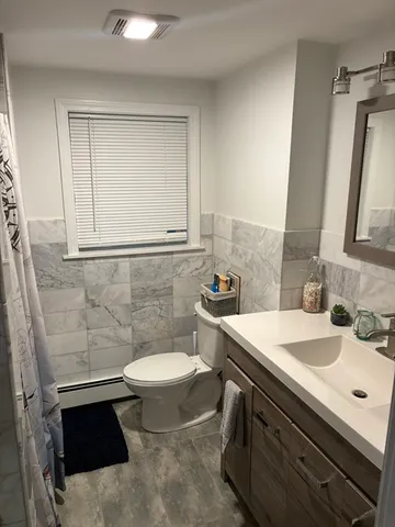 a bathroom with a sink toilet and mirror