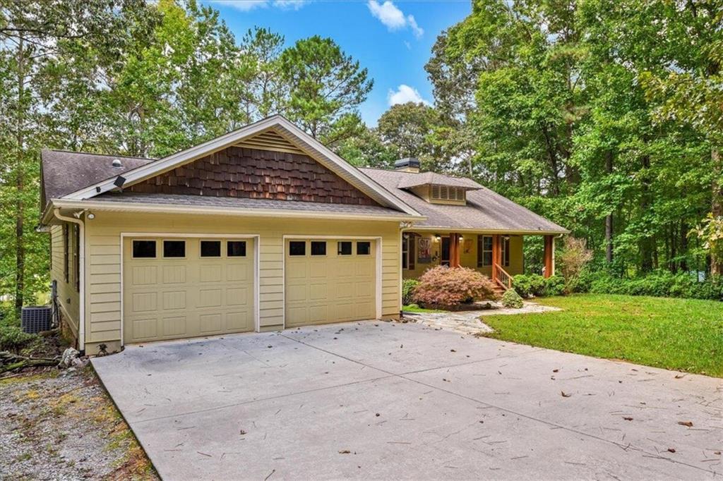 1813 4 Notch Road Carrollton, GA 30116 - Photo 1 of 1 a front view of a house with a garden and trees