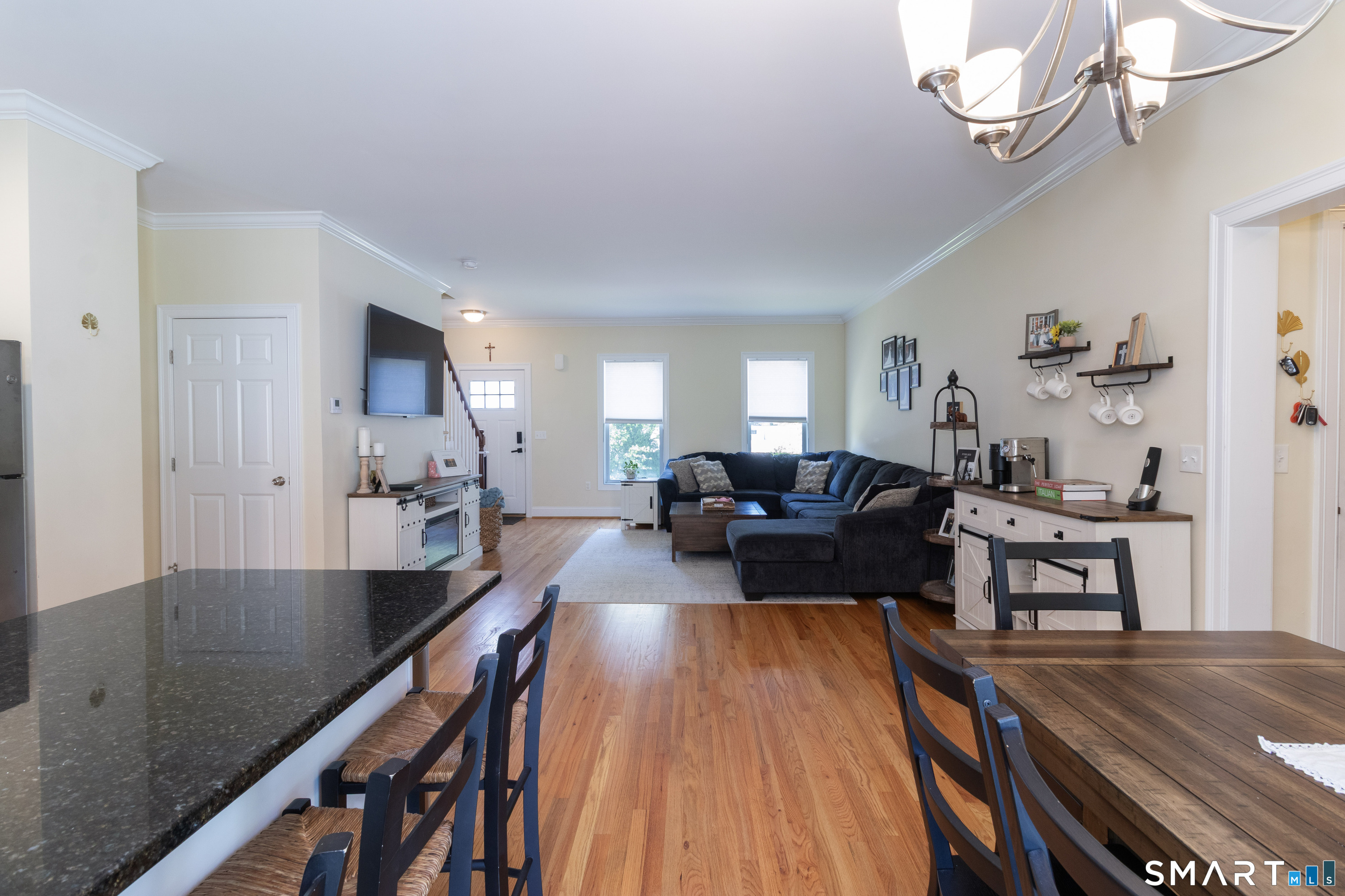 656 Bartholomew Road, Unit 656 Middletown, CT 06457 - Photo 16 of 27 a living room with furniture wooden floor and a chandelier