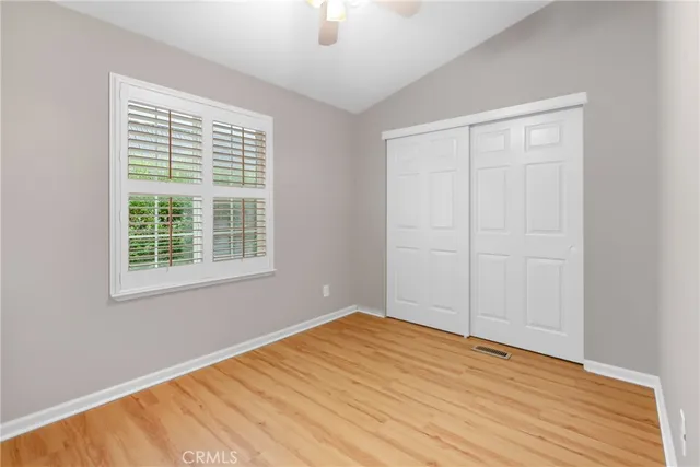 a spacious bedroom with a bed a table and chair