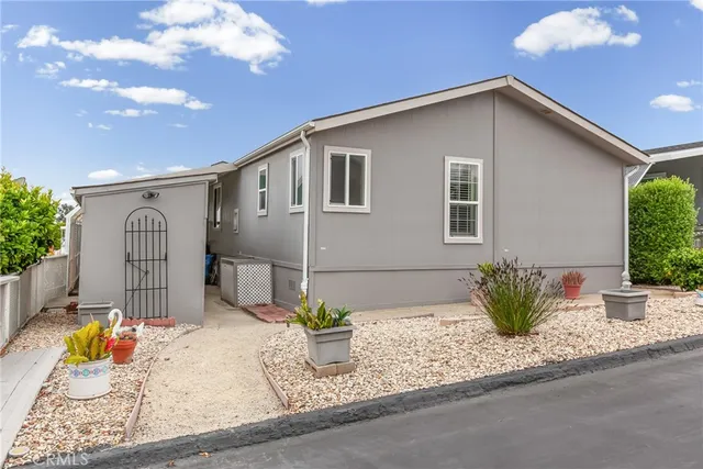 a backyard of a house with table and chairs