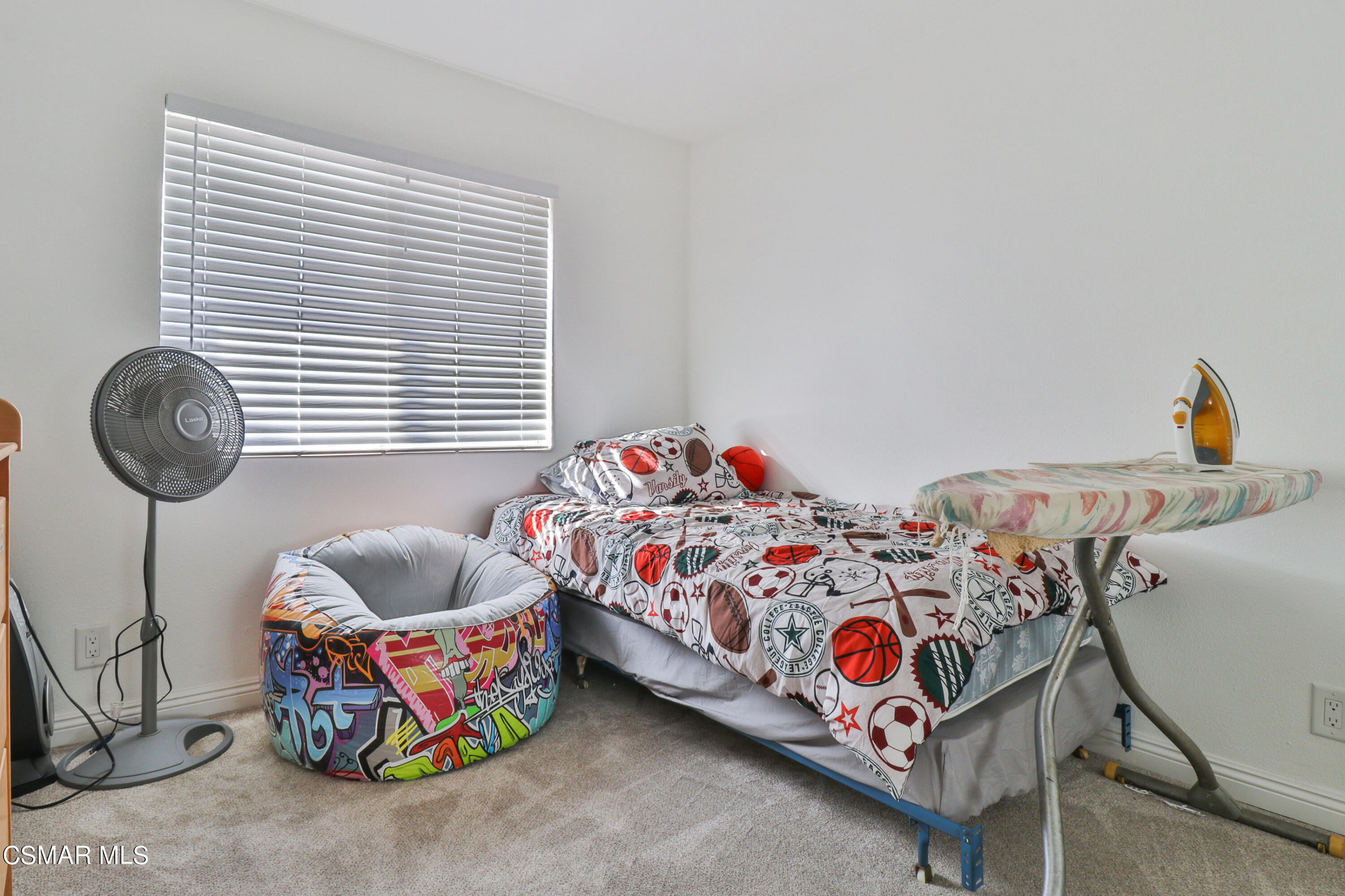 5239 Perkins Road Oxnard, CA 93033 - Photo 11 of 25 a bedroom with two beds and a chandelier