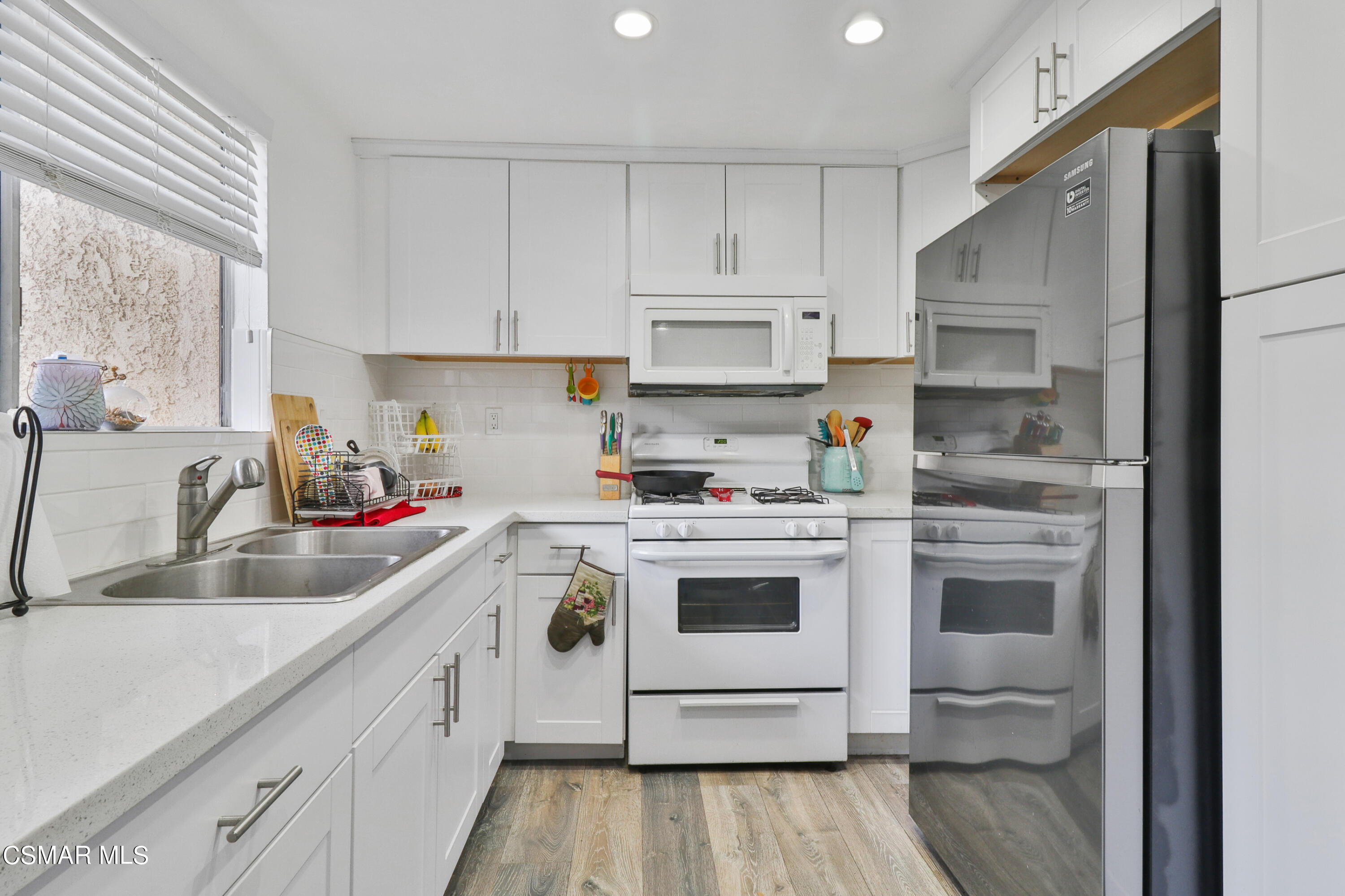 5239 Perkins Road Oxnard, CA 93033 - Photo 5 of 25 a kitchen with cabinets a sink and appliances