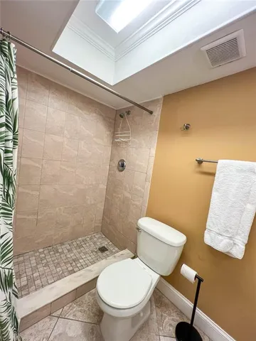 a bathroom with a toilet and a shower