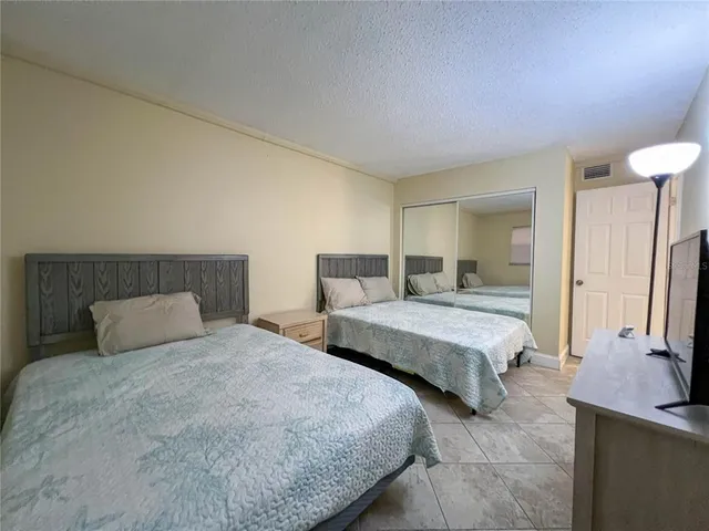 a bedroom with two beds and a chandelier