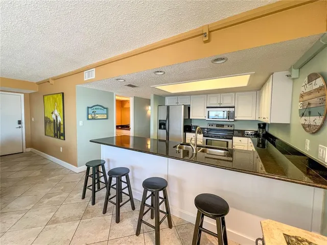 a kitchen with furniture and a view of living room