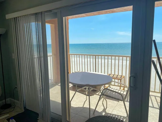 a view of a balcony with chairs and table