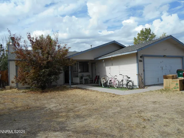 a view of a house with a yard and garage