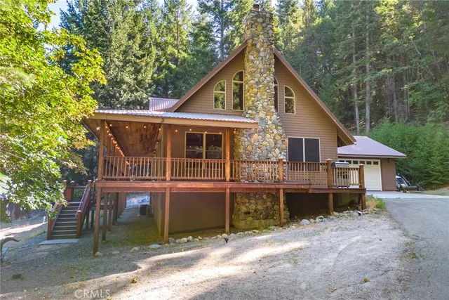 a view of a house with a yard and balcony