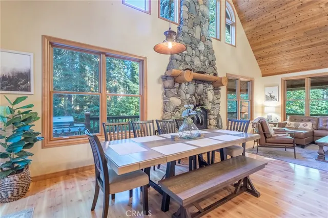 a view of a dining room with furniture wooden floor and a chandelier