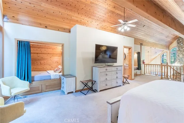 a bedroom with furniture and large window