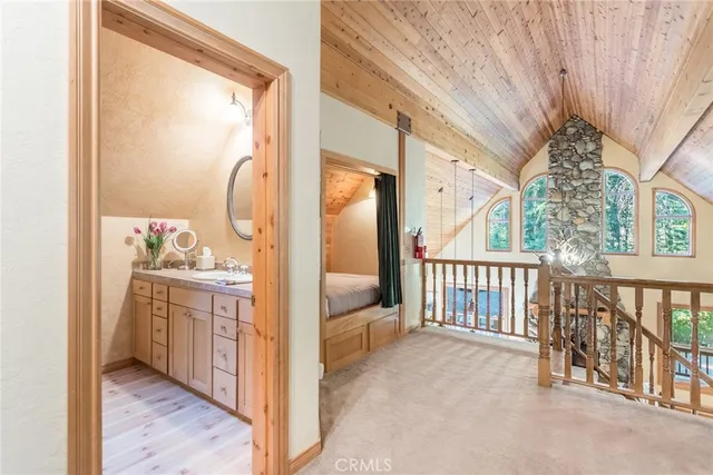 a view of a hallway to a livingroom with furniture