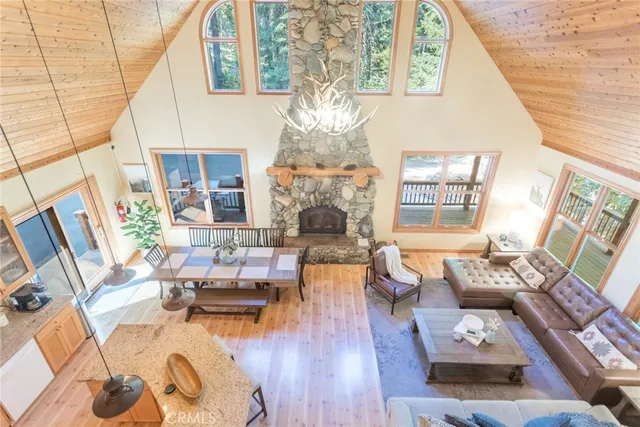a living room with fireplace furniture and a large window