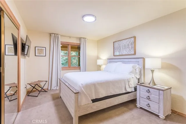 a bedroom with a bed and a table