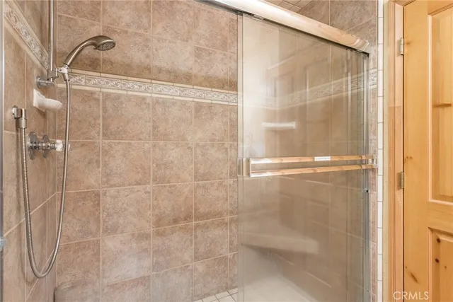 a bathroom with a glass shower door