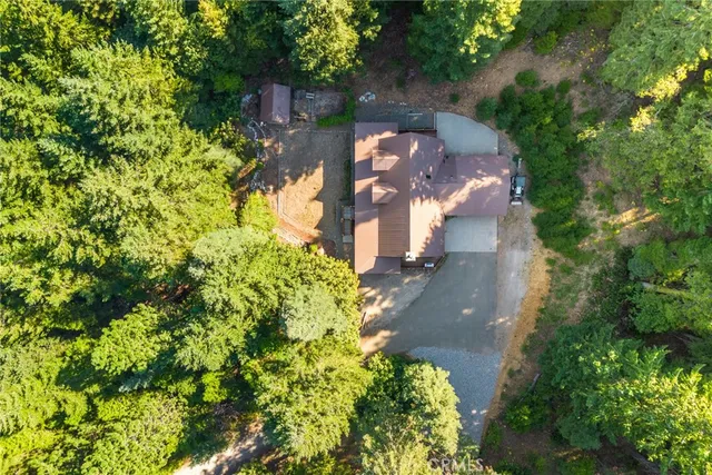 an aerial view of a house with a yard