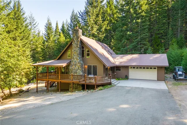 a view of a house with a yard and porch