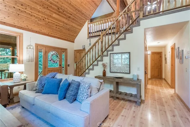 a living room with furniture and a floor to ceiling window