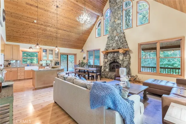 a living room with fireplace furniture and a large window