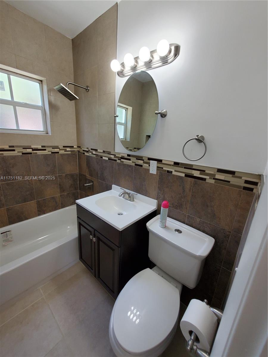 70 Northwest 33rd Street Miami, FL 33127 - Photo 30 of 48 a bathroom with a toilet sink and mirror