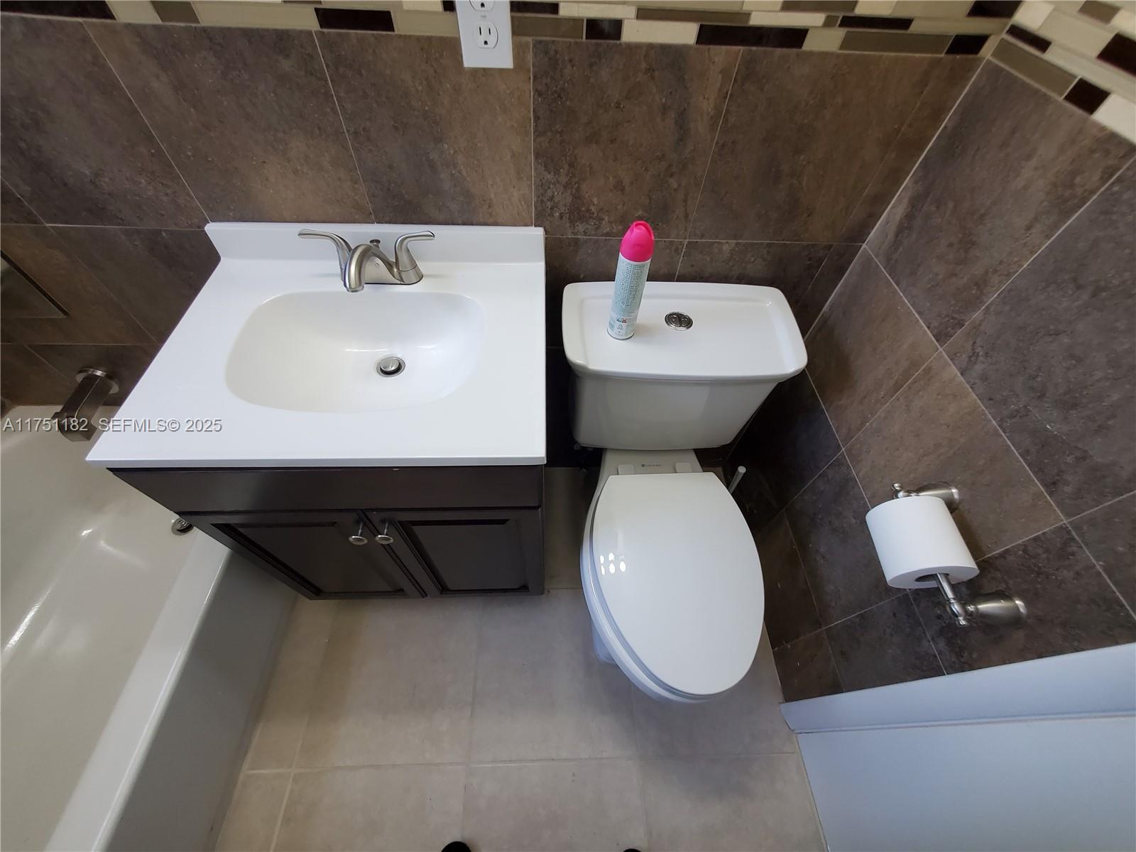 70 Northwest 33rd Street Miami, FL 33127 - Photo 32 of 48 a bathroom with a sink a toilet and a mirror