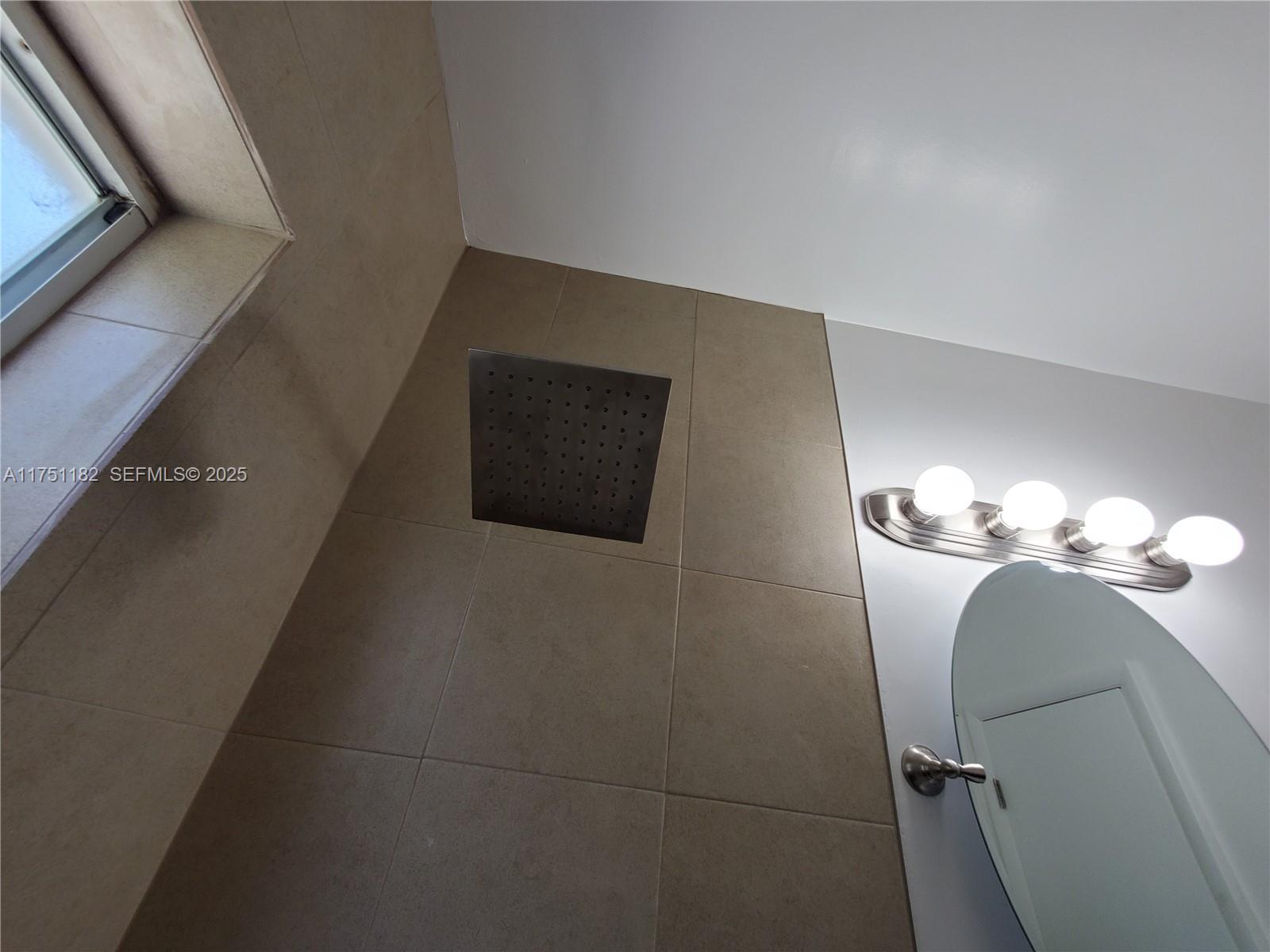 70 Northwest 33rd Street Miami, FL 33127 - Photo 33 of 48 a bathroom with a mirror and a sink
