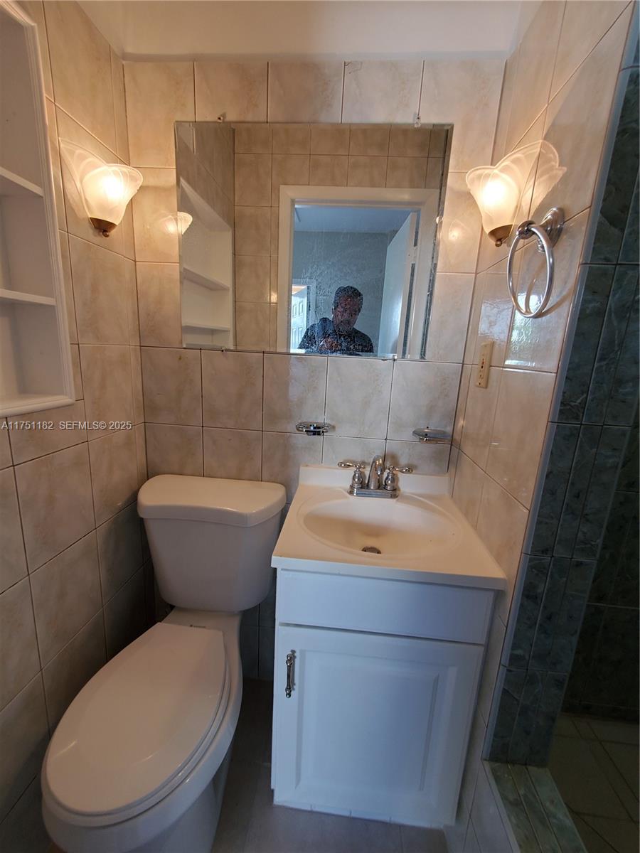 70 Northwest 33rd Street Miami, FL 33127 - Photo 37 of 48 a bathroom with a toilet sink and mirror