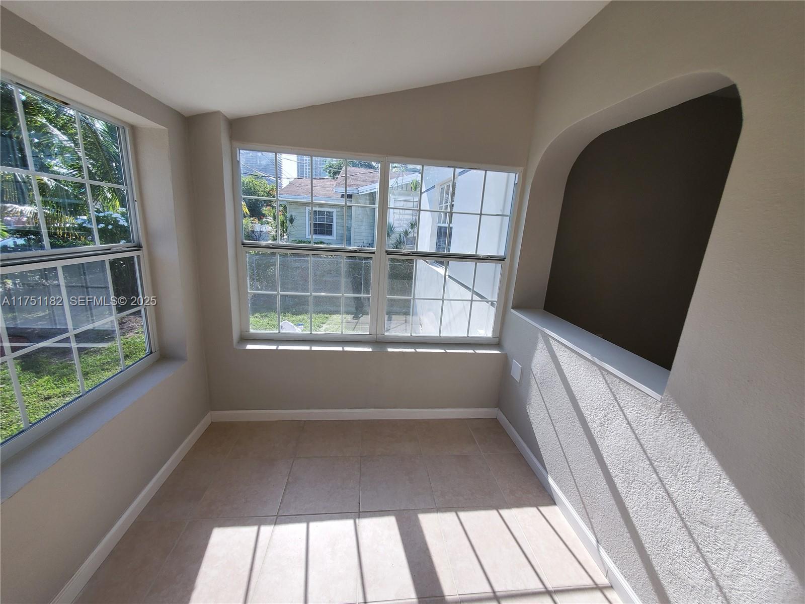 70 Northwest 33rd Street Miami, FL 33127 - Photo 8 of 48 a view of a porch with wooden floor and a window