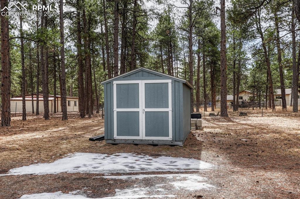 15430 Bar X Road Colorado Springs, CO 80908 - Photo 48 of 50 a front view of a house with a yard