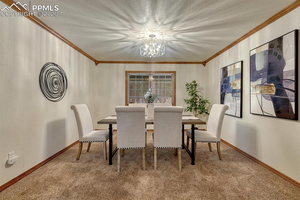 15430 Bar X Road Colorado Springs, CO 80908 - Photo 7 of 50 a view of a dining room with furniture window and outside view