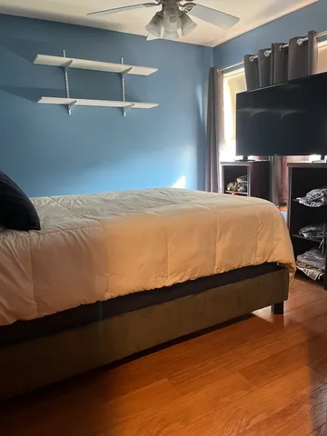 a bed sitting in a bedroom next to a window