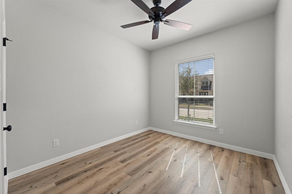 1568 Reverie Road Burleson, TX 76028 - Photo 11 of 26 wooden floor in an empty room with a window
