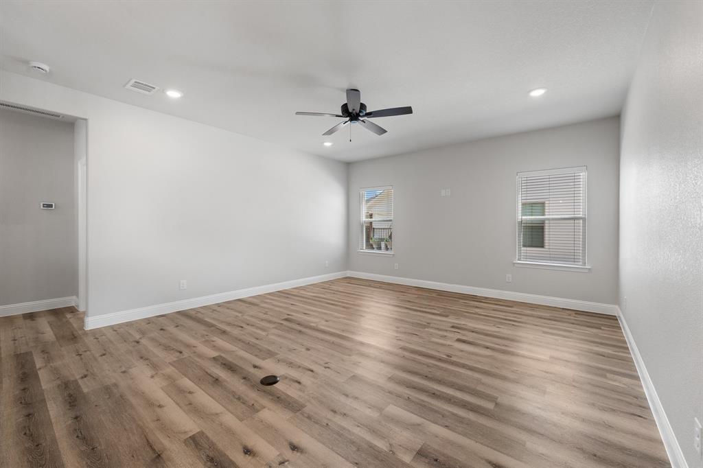 1568 Reverie Road Burleson, TX 76028 - Photo 12 of 26 a view of empty room with wooden floor and fan