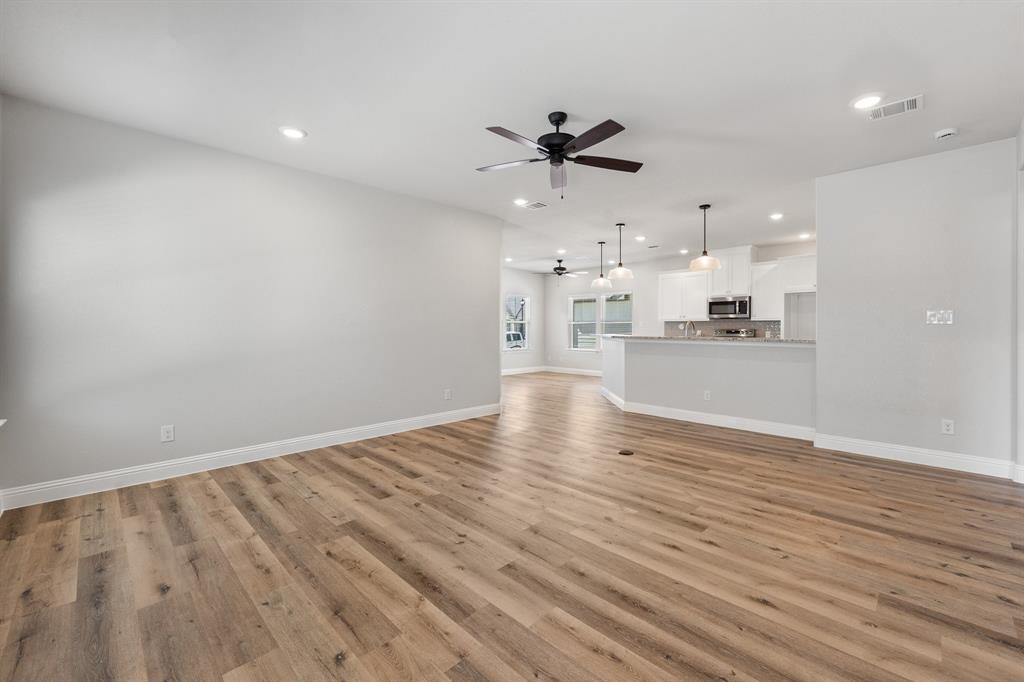 1568 Reverie Road Burleson, TX 76028 - Photo 15 of 26 a view of a kitchen with a sink and wooden floor