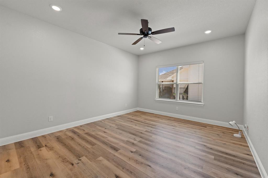 1568 Reverie Road Burleson, TX 76028 - Photo 16 of 26 a view of empty room with wooden floor and fan